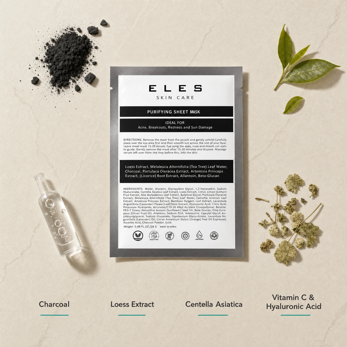 ELES Purifying Sheet Mask ingredient flatlay featuring charcoal, loess extract, centella asiatica, and vitamin C and hyaluronic acid with charcoal powder, green tea leaves and dried herbs on a warm limestone surface