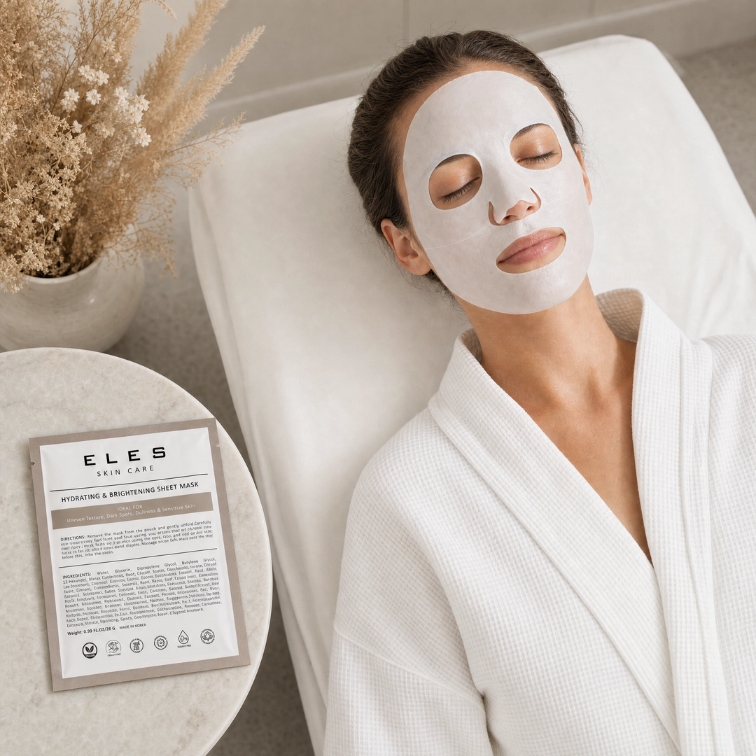 ELES Hydrating and Brightening Sheet Mask applied during a clinical skincare treatment, woman relaxing on treatment bed in white robe, taupe foil sachet on marble side table, uneven texture and dullness treatment