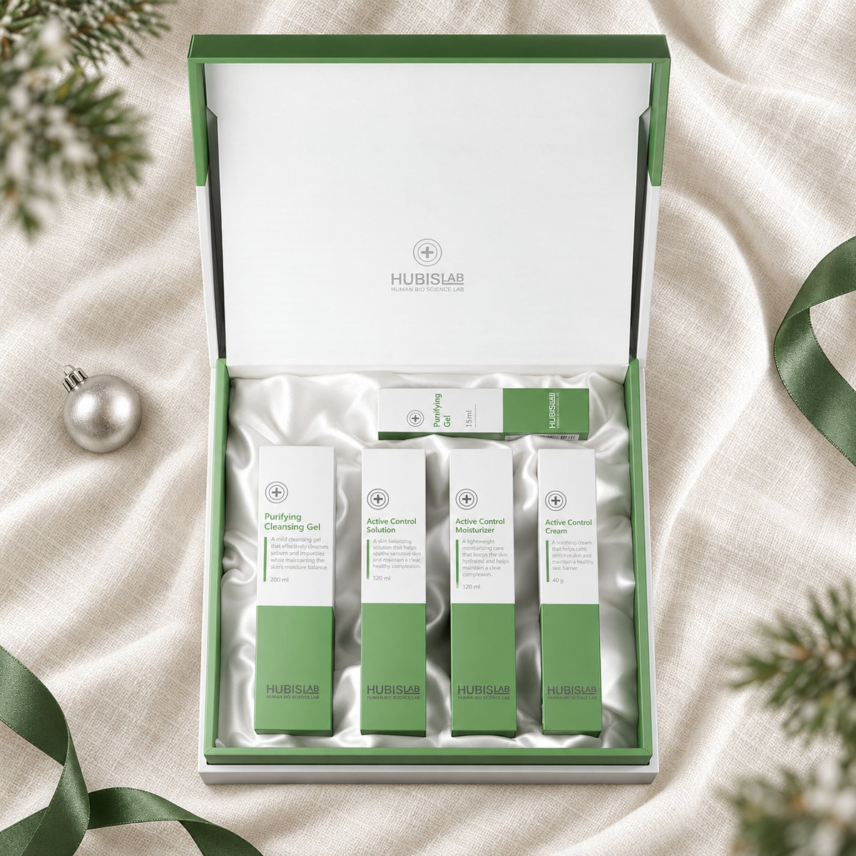 HUBISLAB A.C. Clearing Line Christmas Gift Set in an open gift box on ivory fabric. File: hubislab-a-c-clearing-line-christmas-gift-set-box-flatlay-2026.png