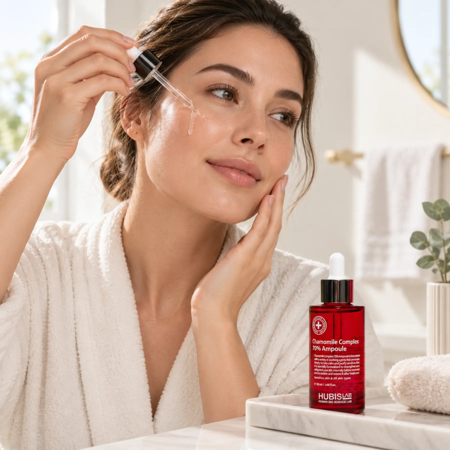 Woman applying HUBISLAB Chamomile Complex 70% Ampoule 50 ml during her calming homecare skincare routine.