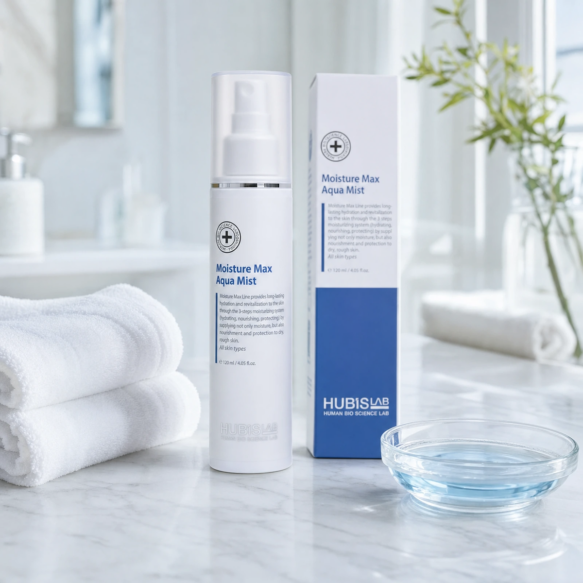 Hubislab Moisture Max Aqua Mist 120ml displayed on a clean premium bathroom vanity with soft towels, product box and a subtle blue hydration cue.