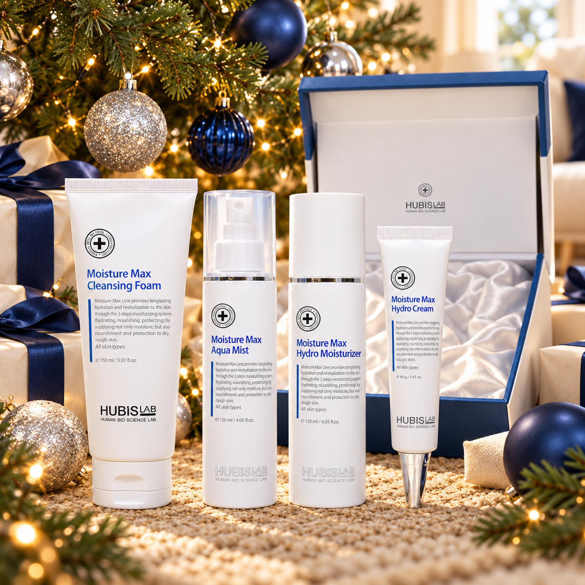 HUBISLAB Moisture Max Christmas Gift Set displayed beside a Christmas tree. File: hubislab-moisture-max-christmas-gift-set-christmas-tree-2026.png
