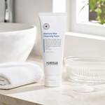 Hubislab Moisture Max Cleansing Foam 150ml displayed on a clean premium bathroom vanity with a soft towel, glass dish and subtle foam cue.