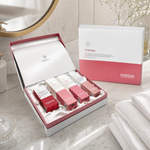 Hubislab Post Rays Deluxe Set displayed in a premium bathroom setting with open presentation box, closed gift box, soft towels and clean clinical-luxury post-care styling.