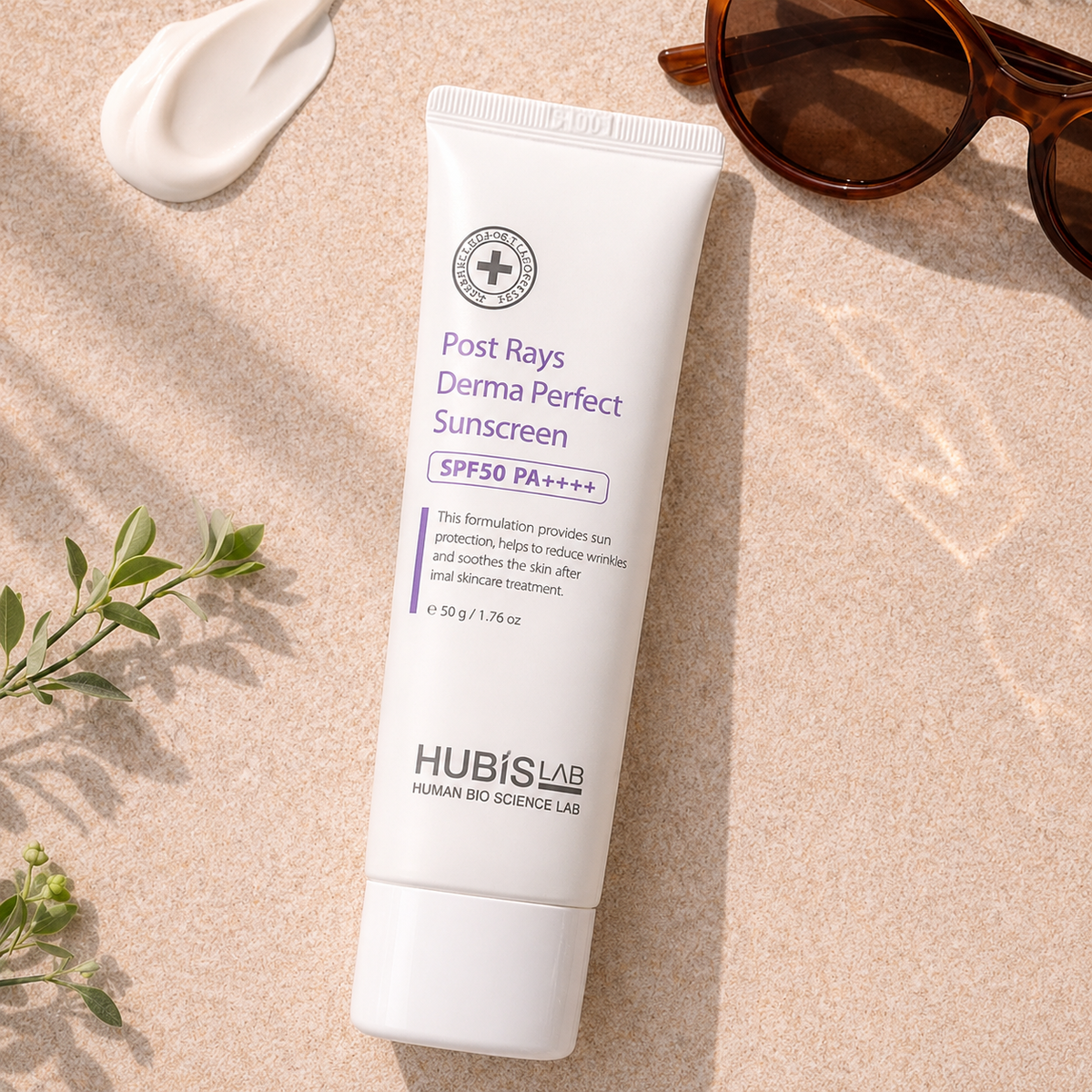 Tube of Hubislab Post Rays Derma Perfect Sunscreen SPF50 PA++++ on a summer skincare flatlay with sunglasses, cream texture and greenery.