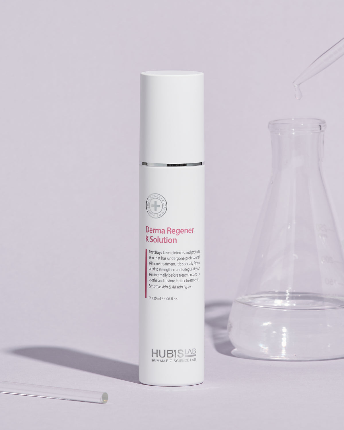 A white bottle of Post Rays Derma Regener K Solution by Hubislab with glass jar next to it