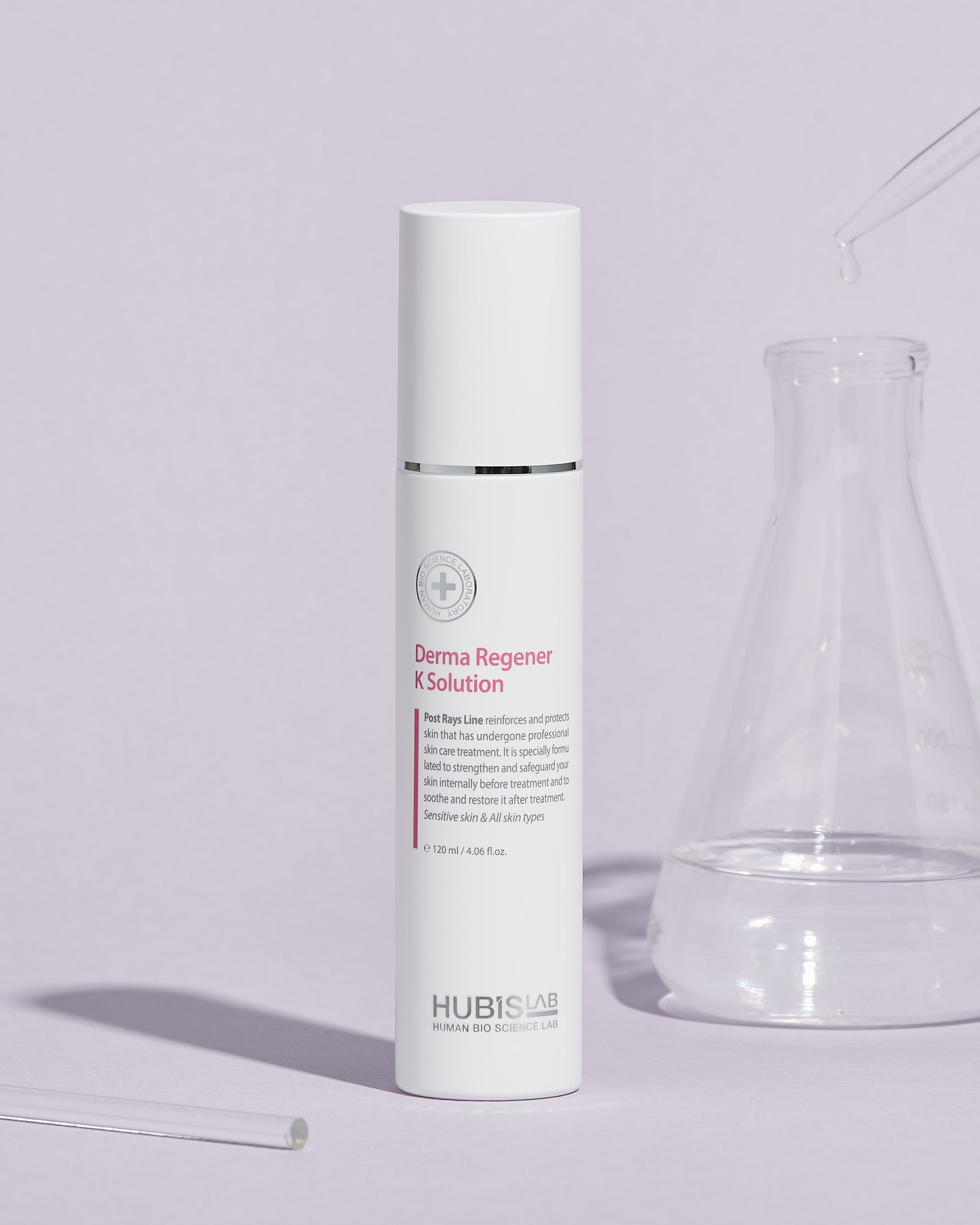 A white bottle of Post Rays Derma Regener K Solution by Hubislab with glass jar next to it