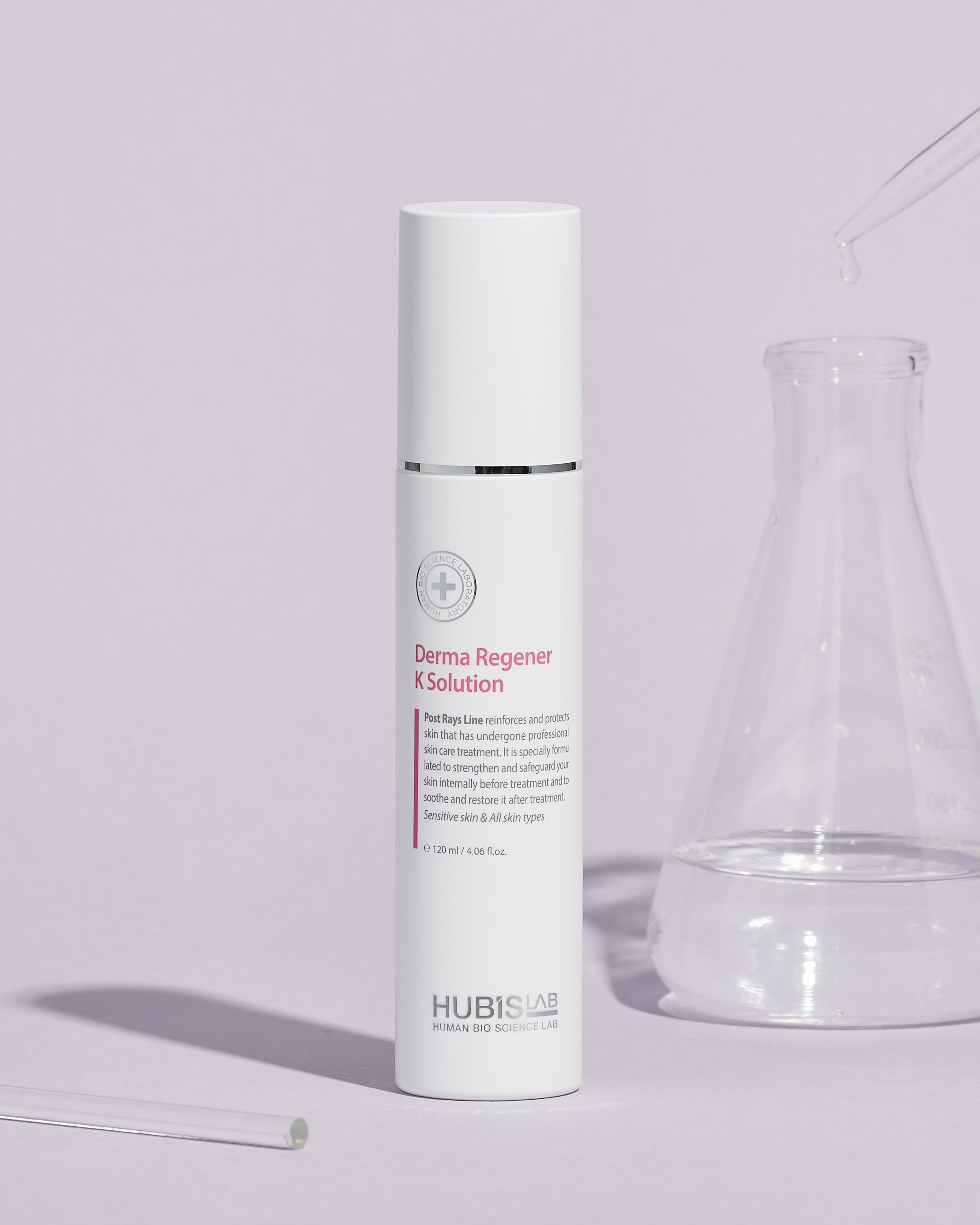 A white bottle of Post Rays Derma Regener K Solution by Hubislab with glass jar next to it