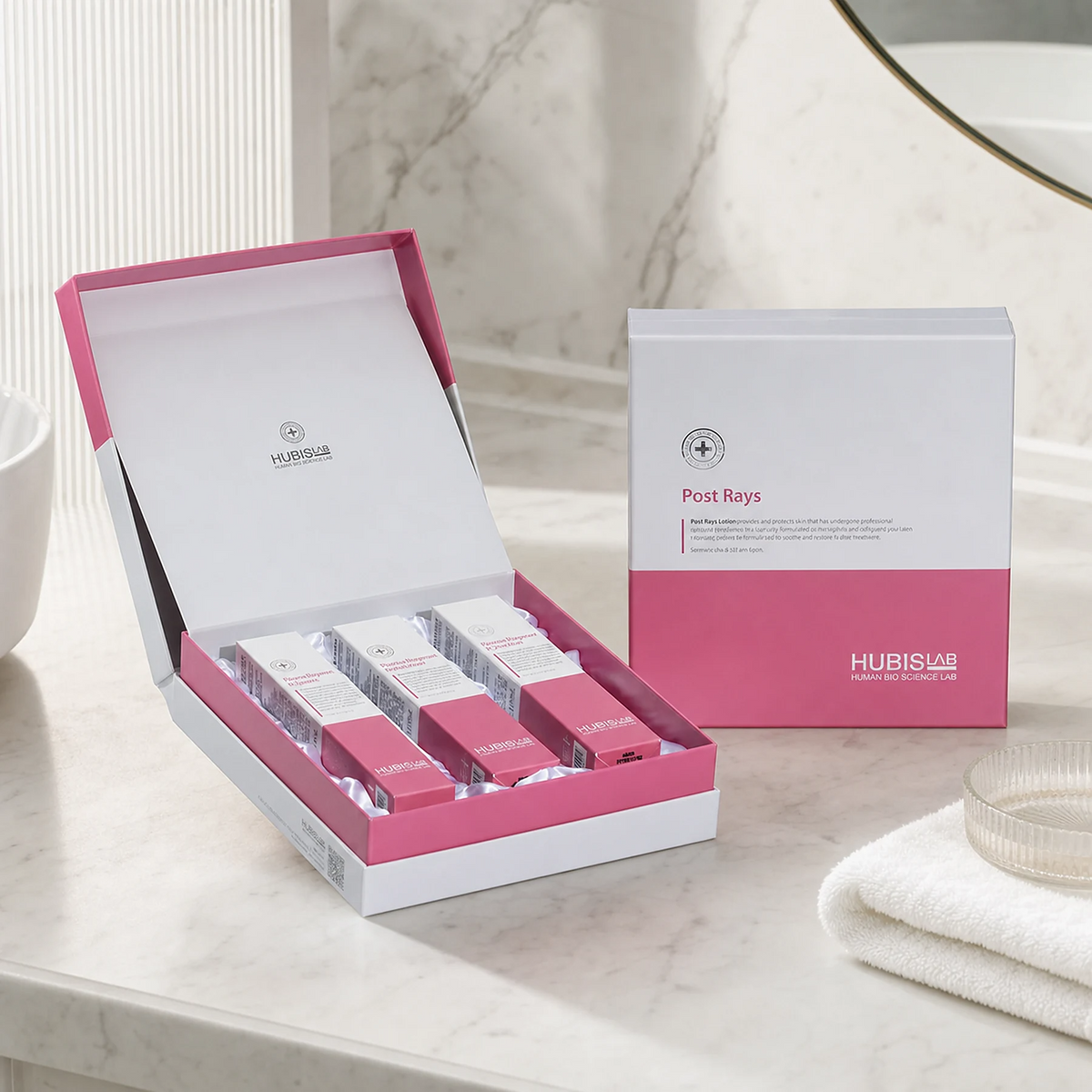 Hubislab Post Rays Gift Set 3 items displayed on a premium bathroom vanity with open presentation box, closed gift box, soft towel and clean clinical-luxury styling.