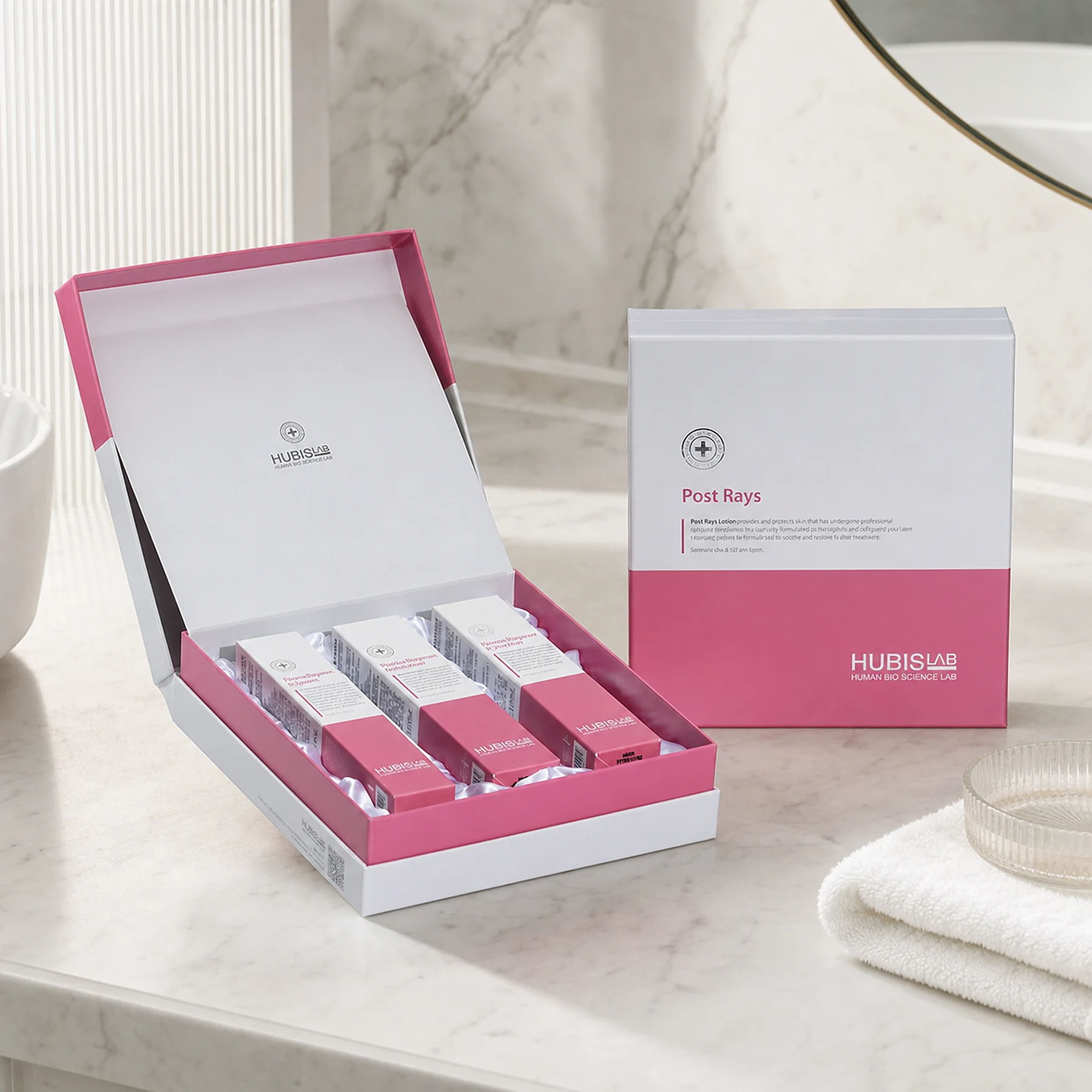 Hubislab Post Rays Gift Set 3 items displayed on a premium bathroom vanity with open presentation box, closed gift box, soft towel and clean clinical-luxury styling.