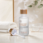 Hubislab Premium Active B-tol Ampoule 30ml displayed on a clean premium bathroom vanity with a soft towel, glass dish and copper serum styling.