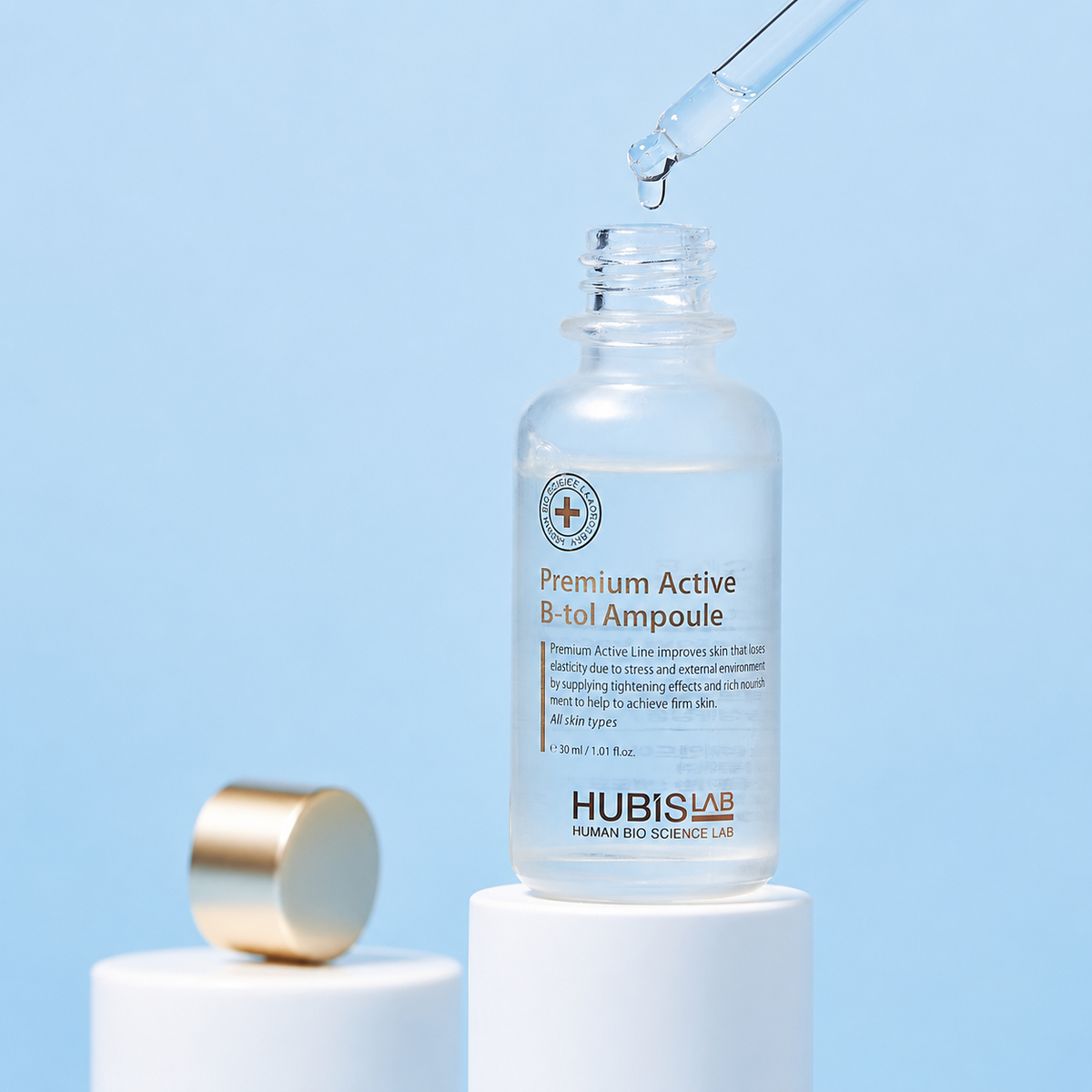 Premium Active B-tol Ampoule 30ml dropper dripping serum texture image on a blue background