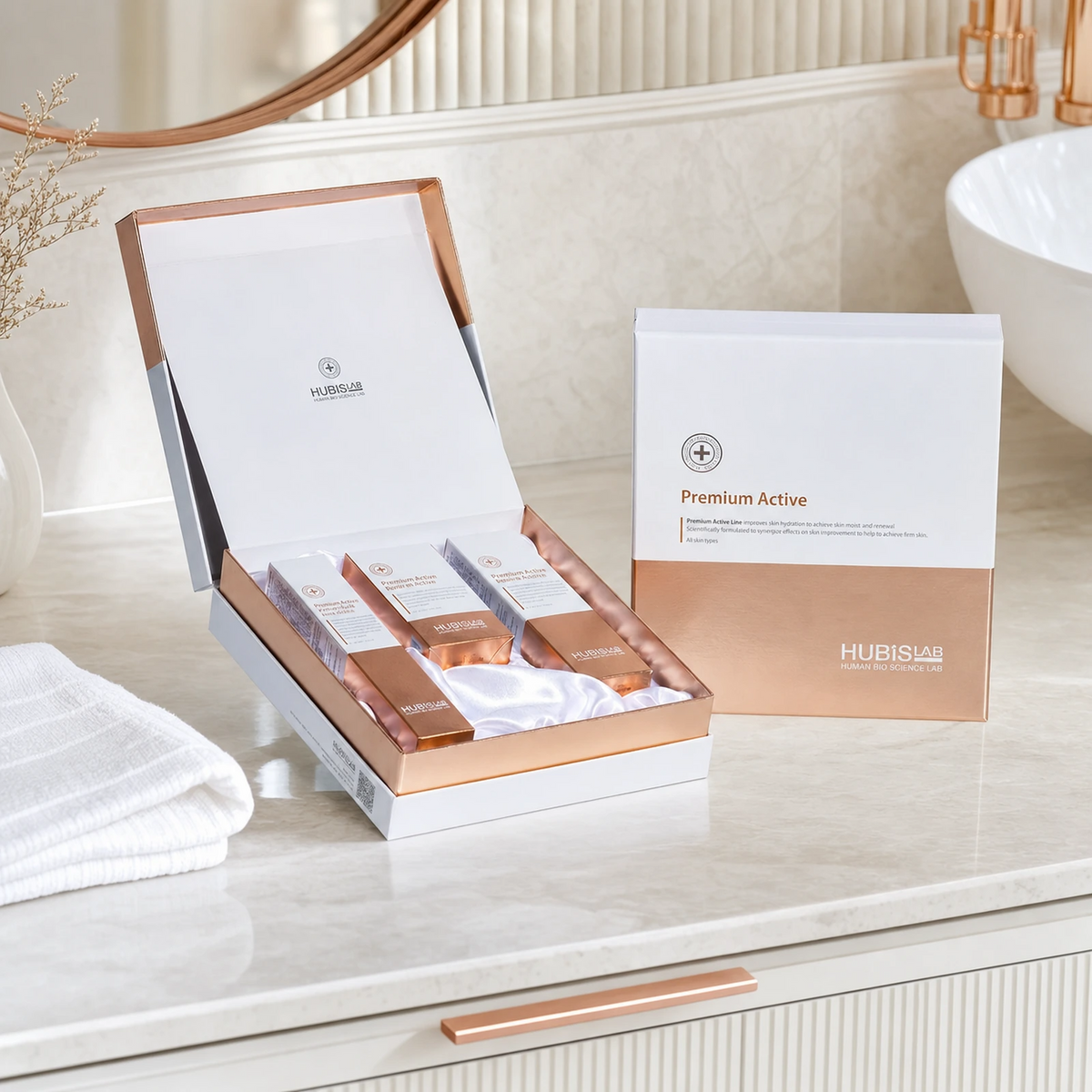 Hubislab Premium Active Gift Set displayed on a clean premium bathroom vanity with soft towels, rose-gold detailing and clinical-luxury styling.
