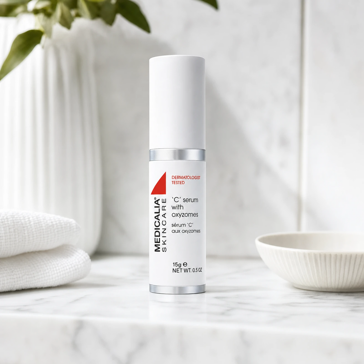 Medicalia C Serum with Oxyzomes 15ml on a premium marble bathroom vanity, a potent Vitamin C serum with oxyzome encapsulation technology for brightening, firming, and fading hyperpigmentation.