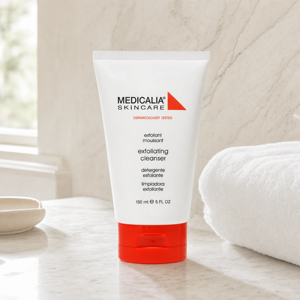 Medicalia Exfoliating Cleanser 150ml on a premium marble bathroom vanity, a gentle daily exfoliating face wash with lactic acid and jojoba for smooth, clear, bright skin.