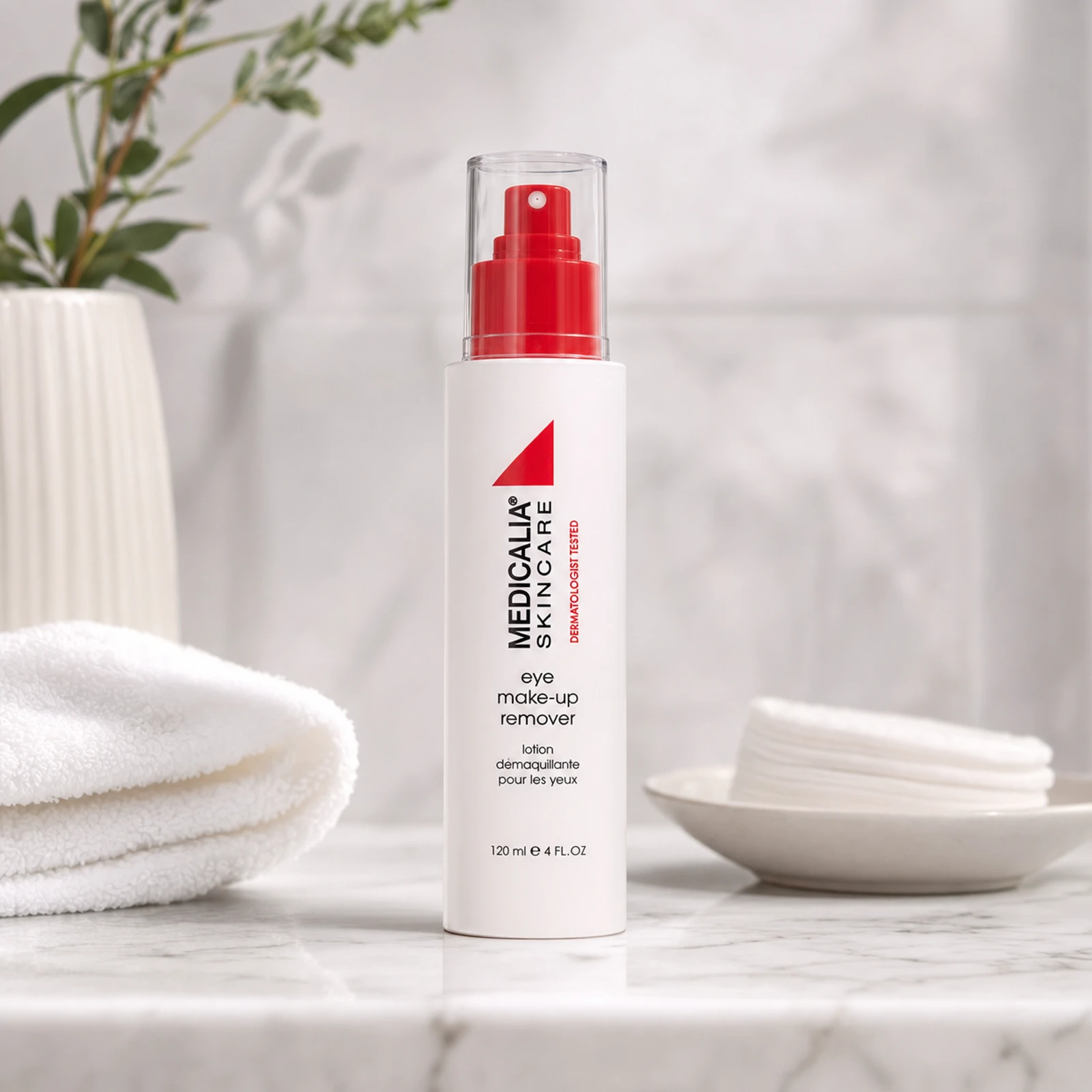 Medicalia Eye Make-Up Remover 120ml on a premium marble bathroom vanity with cotton pads, a gentle hydrating eye makeup remover for all skin types including sensitive and post-procedure.
