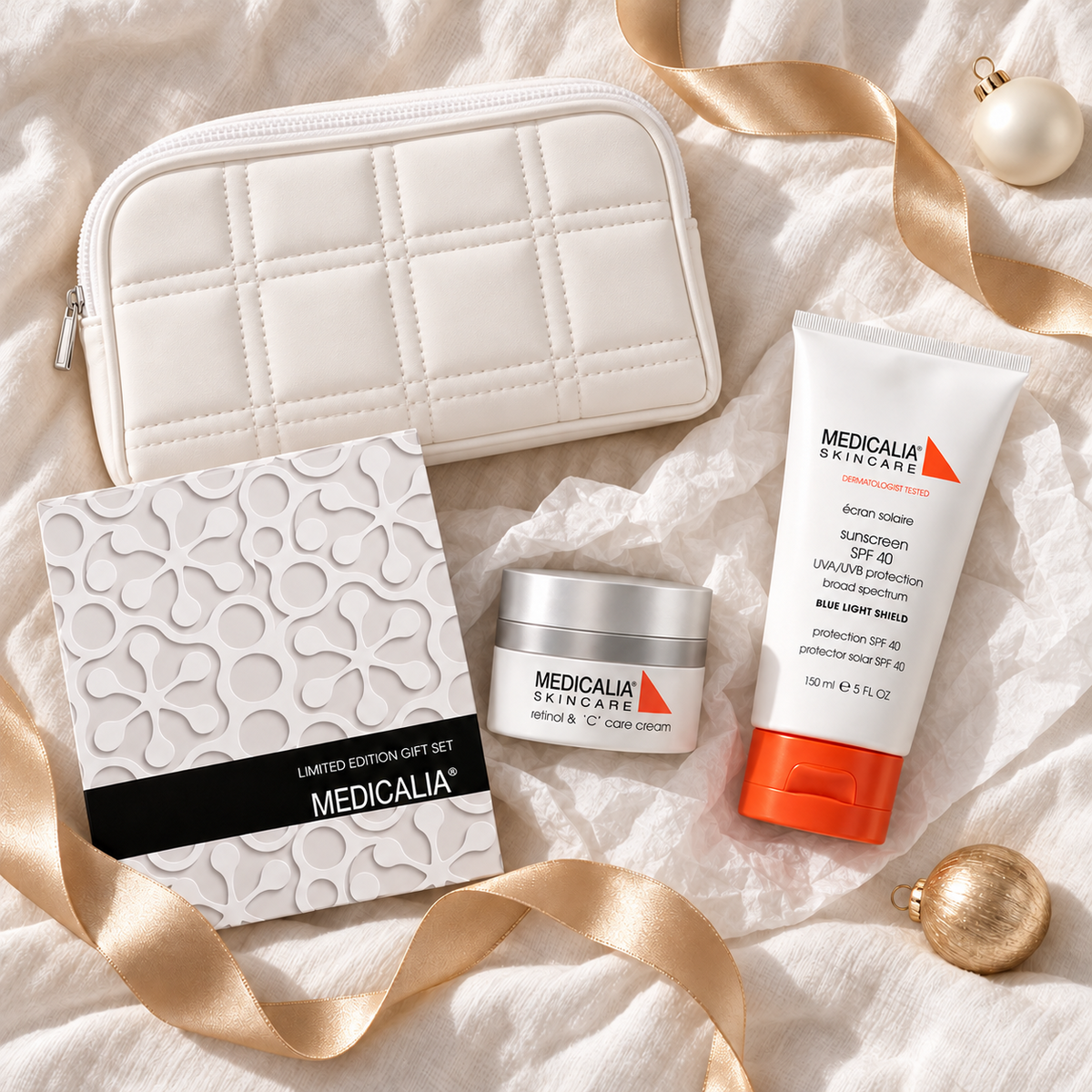 MEDICALIA Retinol and C & Sunscreen Gift Bag arranged in a festive flatlay. File: medicalia-retinol-and-c-and-sunscreen-gift-bag-christmas-flatlay-2026.png
