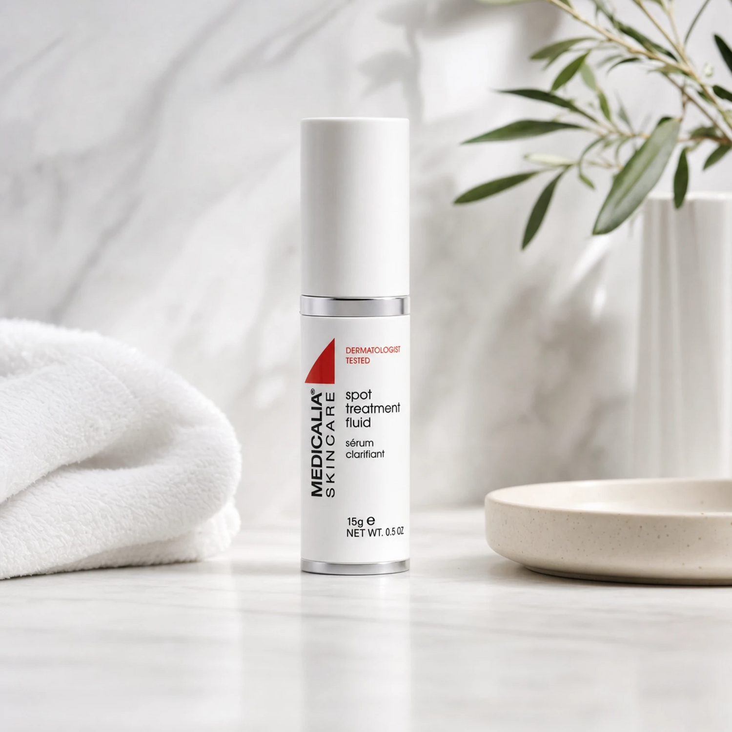 Medicalia Spot Treatment Fluid 15ml on a premium marble bathroom vanity, a fast-acting professional-grade blemish treatment with salicylic and glycolic acids for acne-prone skin.