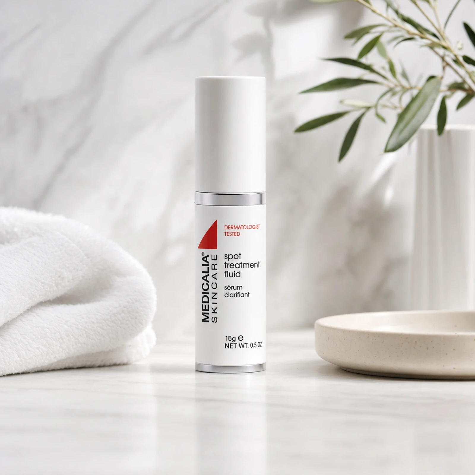 Medicalia Spot Treatment Fluid 15ml on a premium marble bathroom vanity, a fast-acting professional-grade blemish treatment with salicylic and glycolic acids for acne-prone skin.