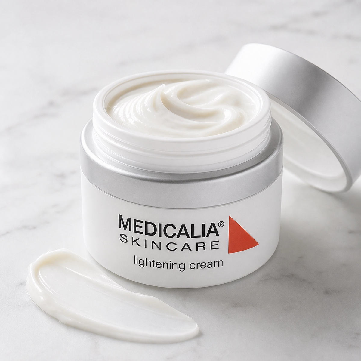 Medicalia Skincare lightening cream jar with open lid on a marble surface