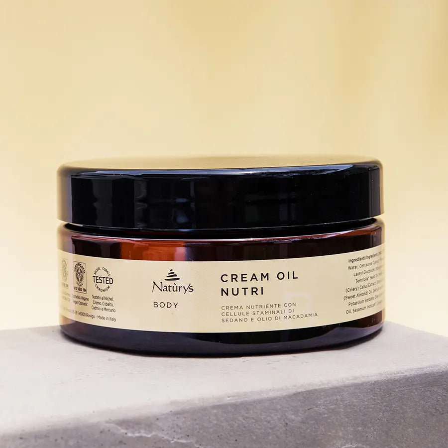 Naturys Body Cream Oil Nutri 250ml premium amber glass jar styled on a stone.