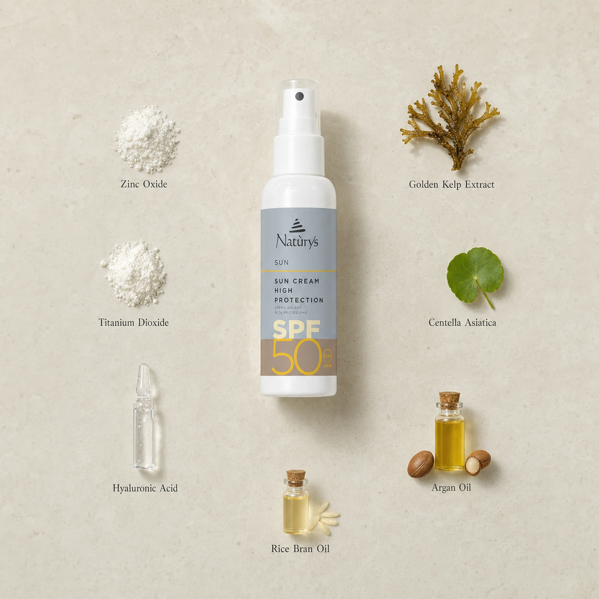 Naturys Sun Cream High Protection SPF 50 Spray 100ml surrounded by labelled key ingredients including Zinc Oxide, Titanium Dioxide, Hyaluronic Acid, Golden Kelp Extract, Centella Asiatica, Argan Oil and Rice Bran Oil on a warm travertine stone surface