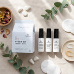Natur's Hydra Kit travel size with skincare products on a textured surface with greenery.