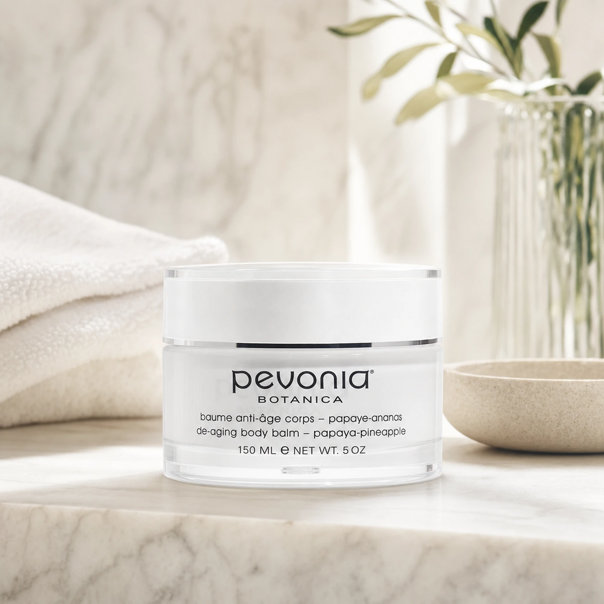 Pevonia Body Balm Papaya-Pineapple 150ml on a luxury bathroom vanity for dry, dull and ageing body skin