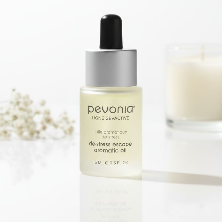 Pevonia De-Stress Escape Aromatic Oil 15ml on a luxury bathroom vanity for dry, tired and sensitive skin
