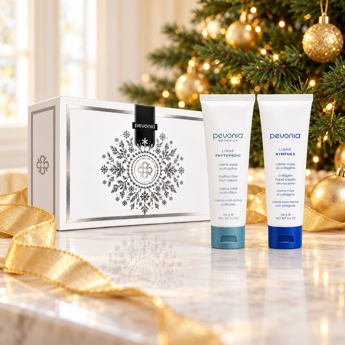Pevonia Hand & Foot Gift Pack displayed beside a Christmas tree. File: pevonia-hand-and-foot-gift-pack-christmas-tree-2026.jpg