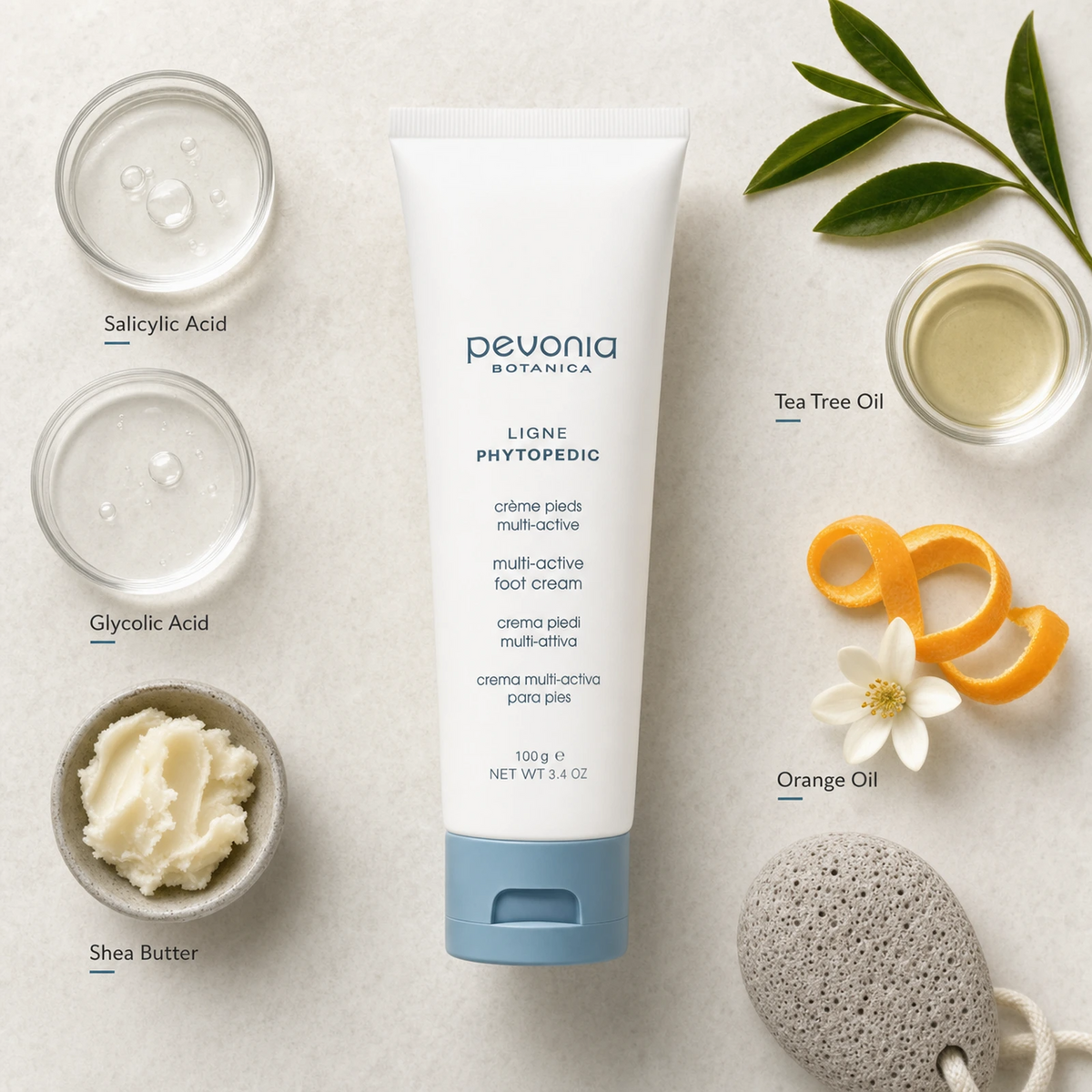 Pevonia Multi-Active Foot Cream 100ml ingredient flatlay with Salicylic Acid, Glycolic Acid, Shea Butter, Tea Tree Oil and Orange Oil