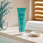 Phytomer Body Declic Cellulite and Contouring Cream 150ml on a marble bath ledge with teal seaweed in glass vessel, white ceramic dish and white towels, premium at-home body care setting