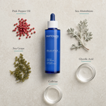 Phytomer Celluli Attack Concentrate 100ml flatlay on limestone surface with Pink Pepper Oil, Sea Absinthium, Sea Grape, Glycolic Acid, and Caffeine