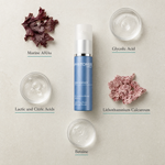 Phytomer Emergence Even Skin Tone Refining Serum 30ml flatlay on limestone surface with Marine AHAs, Glycolic Acid, Lactic and Citric Acids, Lithothamnium Calcareum, and Betaine