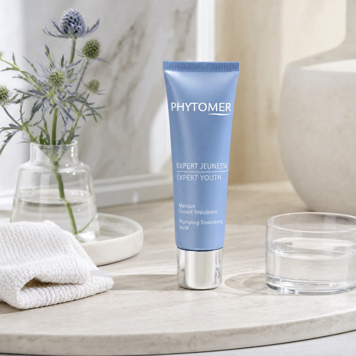Phytomer Expert Youth Plumping Smoothing Mask 50ml on a marble bathroom vanity with sea fennel, glass vessel, white towels and ceramic tray, premium at-home skincare setting