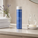 Phytomer Gentle Illuminating Shampoo with Marine Plants 250ml on a marble bathroom vanity with lavender, glass vessel, white towels and ceramic dish, premium at-home haircare setting
