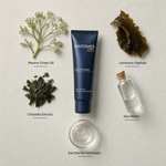 Phytomer Homme Age Optimal Face and Eyes Wrinkle Smoothing Cream 50ml flatlay on limestone surface with Marine Criste Oil, Laminaria Digitata, Chlorella Extract, Sea Water, and Saccharide Isomerate