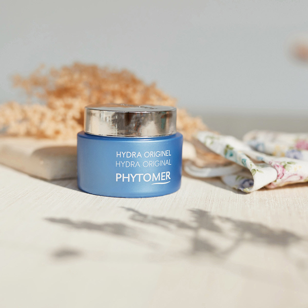 Phytomer Hydra Original Moisturising Melting Cream in a blue jar, displayed in a soft lifestyle setting, delivering long-lasting hydration for dry and dehydrated skin.