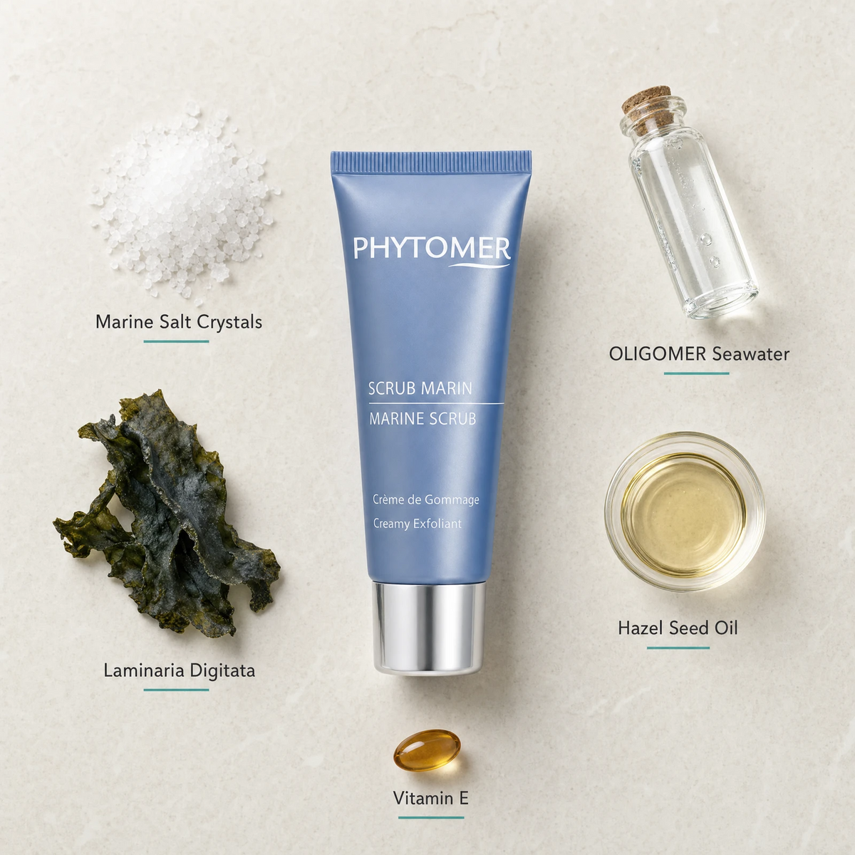 Phytomer Marine Scrub Creamy Exfoliant 50ml flatlay on limestone surface with Marine Salt Crystals, OLIGOMER Seawater, Laminaria Digitata, Hazel Seed Oil, and Vitamin E