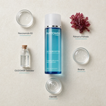 Phytomer Oligobooster Invigorating Moisturizing Body Concentrate 125ml flatlay on limestone surface with Niacinamide B3, Palmaria Palmata, OLIGOMER Seawater, Betaine, and Glycerin