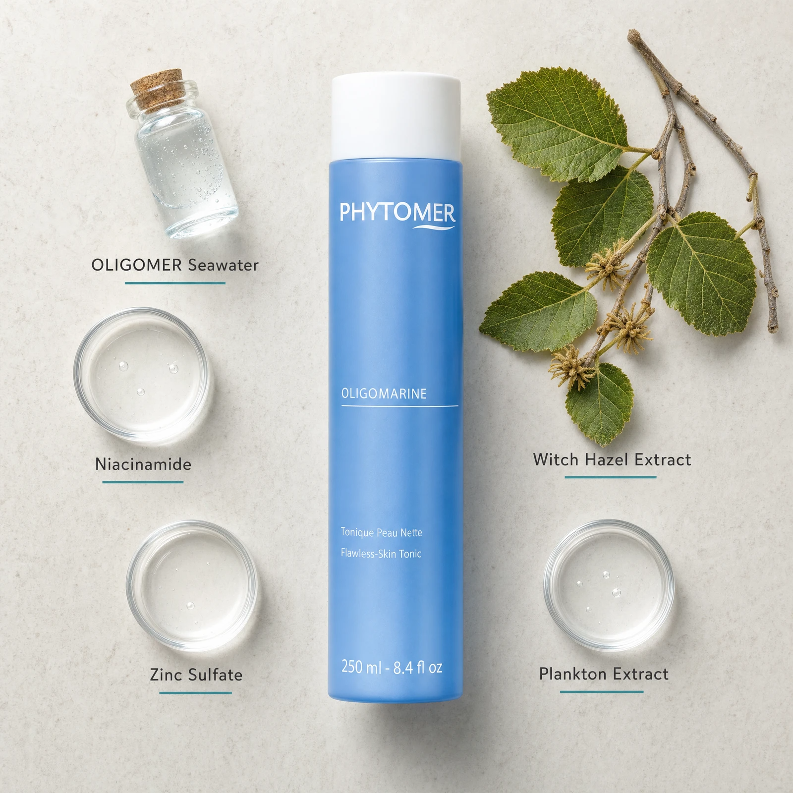 Phytomer Oligomarine Flawless Skin Tonic 250ml flatlay on limestone surface with OLIGOMER Seawater, Niacinamide, Zinc Sulfate, Witch Hazel Extract, and Plankton Extract