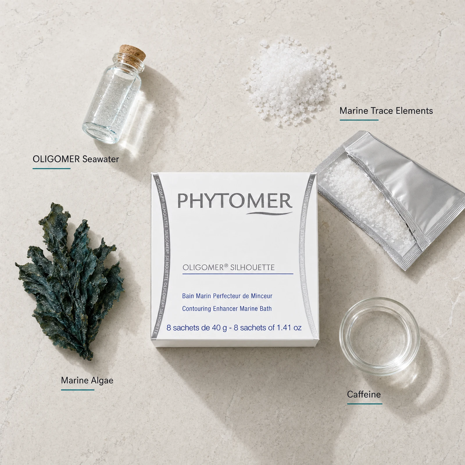 Phytomer Oligomer Silhouette Contouring Enhancer Marine Bath 8 sachets flatlay on limestone surface with OLIGOMER Seawater, Marine Trace Elements, Marine Algae, and Caffeine