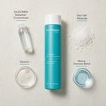 Phytomer Oligomer Well-Being Sensation Essential Minerals Relaxing Bath 250ml flatlay on limestone surface with OLIGOMER Seawater Concentrate, Sea Salt Minerals, Glycerin, and Marine Aromatic Blend