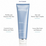 Phytomer Oligopur Purifying Cleansing Gel 150ml on a marble bathroom counter with teal coral in glass carafe, white ceramic soap dish, white waffle towel and soft backlit window, premium at-home skincare setting