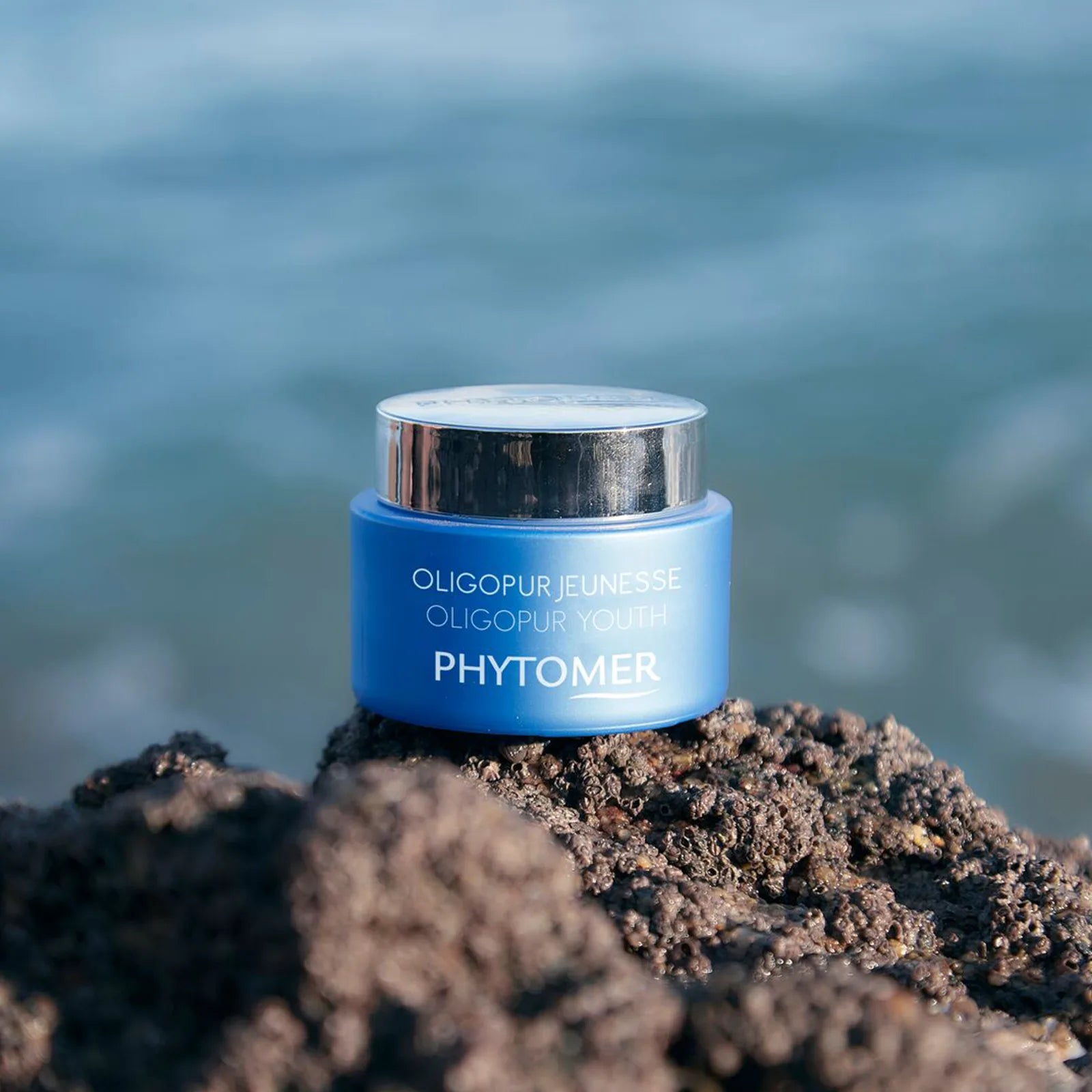 PHYTOMER Oligopur Youth Pores – Blemishes – Wrinkles Targeted Cream 50ml on a rocky surface with a blurred natural background