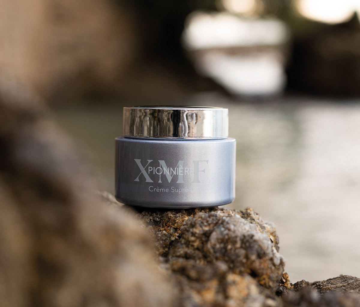 PIONNIERE XMF Youth & Glow Supreme Cream 50 ml sitting on a rock