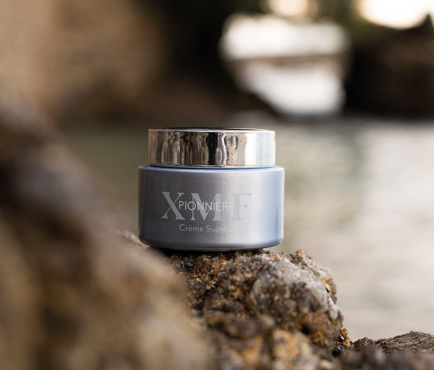 PIONNIERE XMF Youth & Glow Supreme Cream 50 ml sitting on a rock