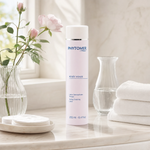 Phytomer Rosee Visage Toning Cleansing Lotion 250ml on a marble bathroom vanity with cotton pads, white towels, glass vessel and fresh rose, premium at-home skincare setting
