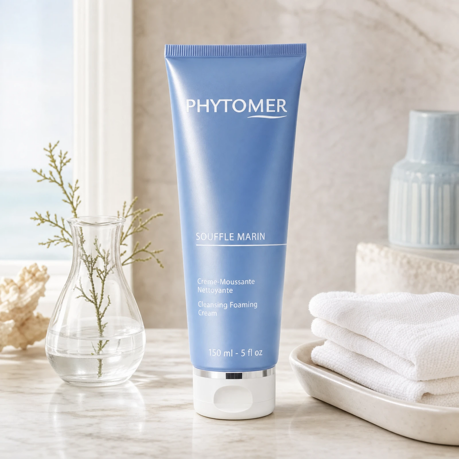Phytomer Souffle Marin Cleansing Foaming Cream 150ml on a marble bathroom vanity with glass vessel, coastal botanical, white towels and ceramic tray, premium at-home skincare setting