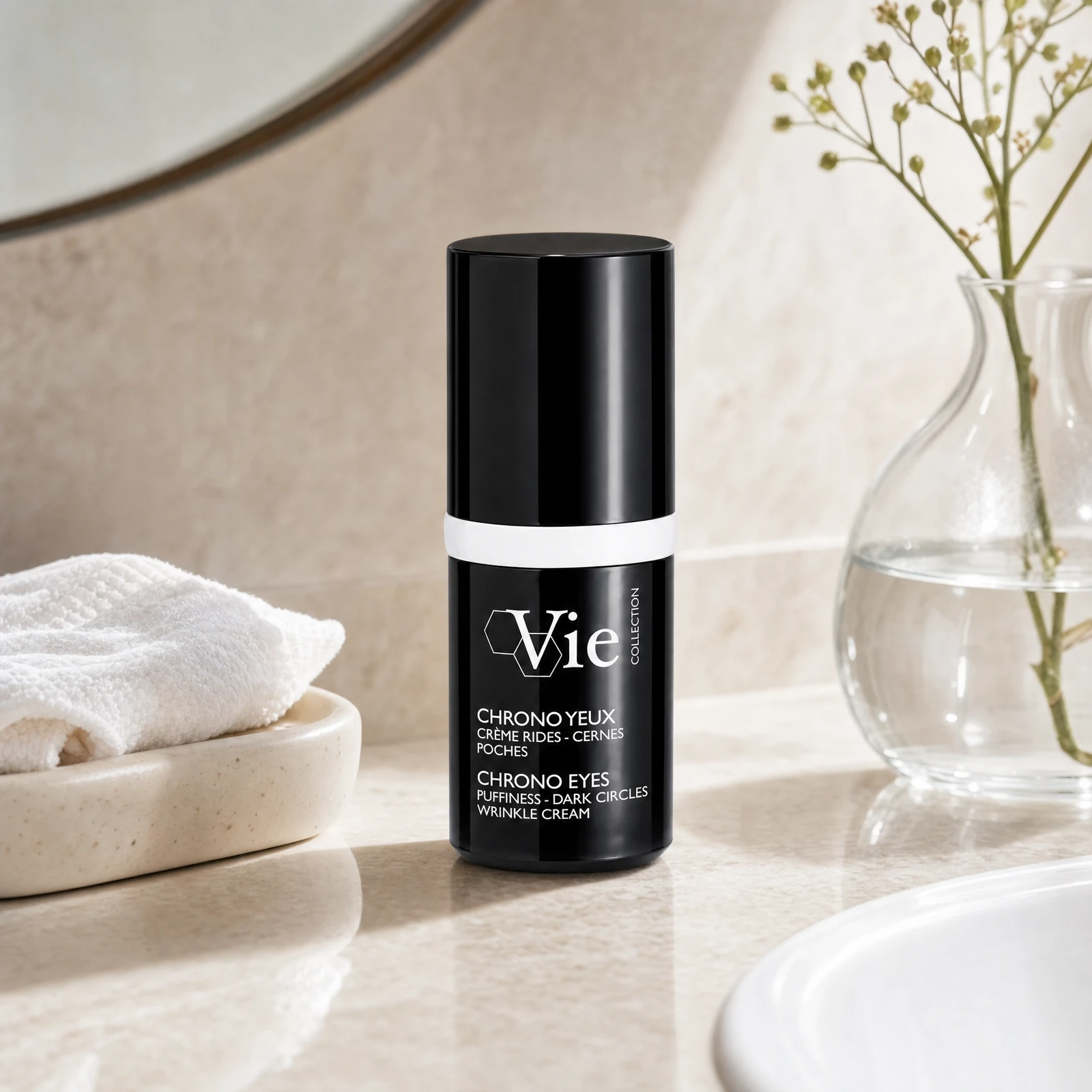 Vie Collection Chrono Eyes Puffiness Dark Circles Wrinkle Cream 15ml on a marble bathroom counter with gypsophila in glass carafe, white waffle towel in stone tray, white basin and round mirror, premium at-home skincare setting